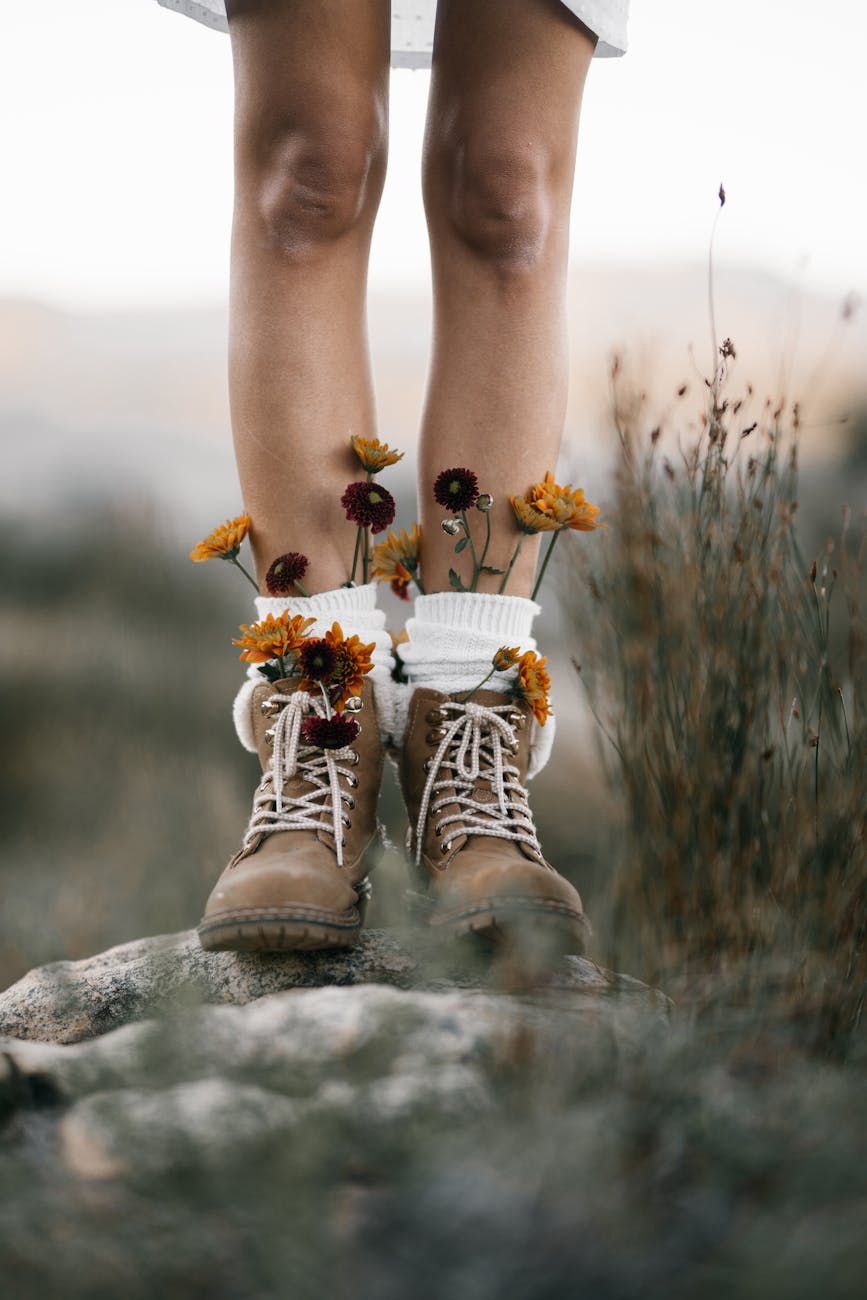 legs wearing boots with flowers sticking out