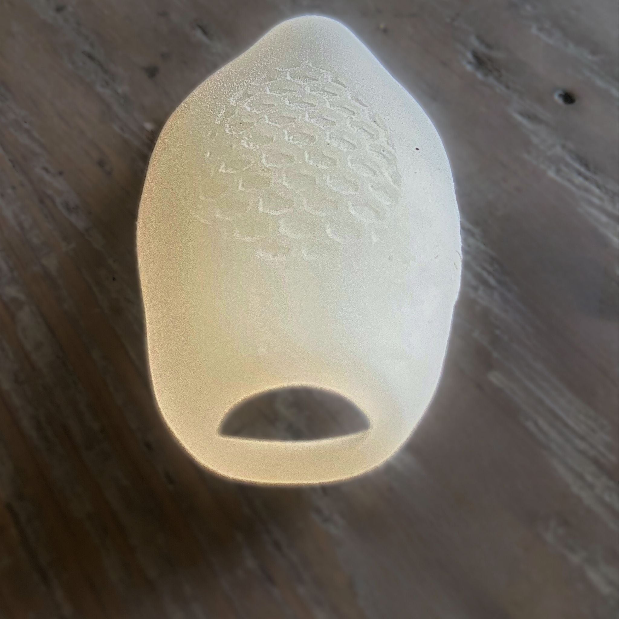 White bunionette gel guard/pad   with textured surface on a wooden surface