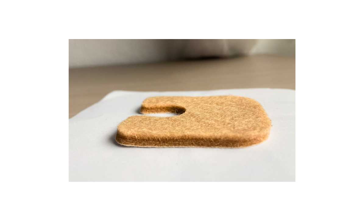 Adhesive felt callus protector on a white surface